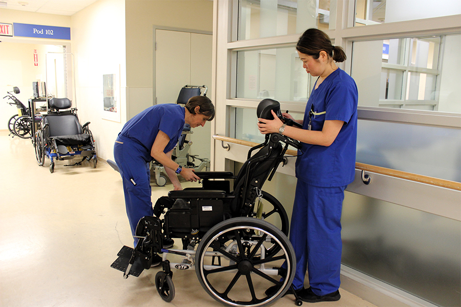 two women setting up a wheelchair